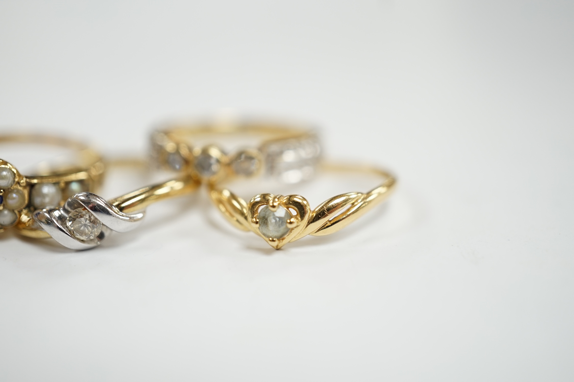 Three assorted modern 9ct gold and diamond set rings, gross 6.5 grams and two other yellow metal and gem set rings.